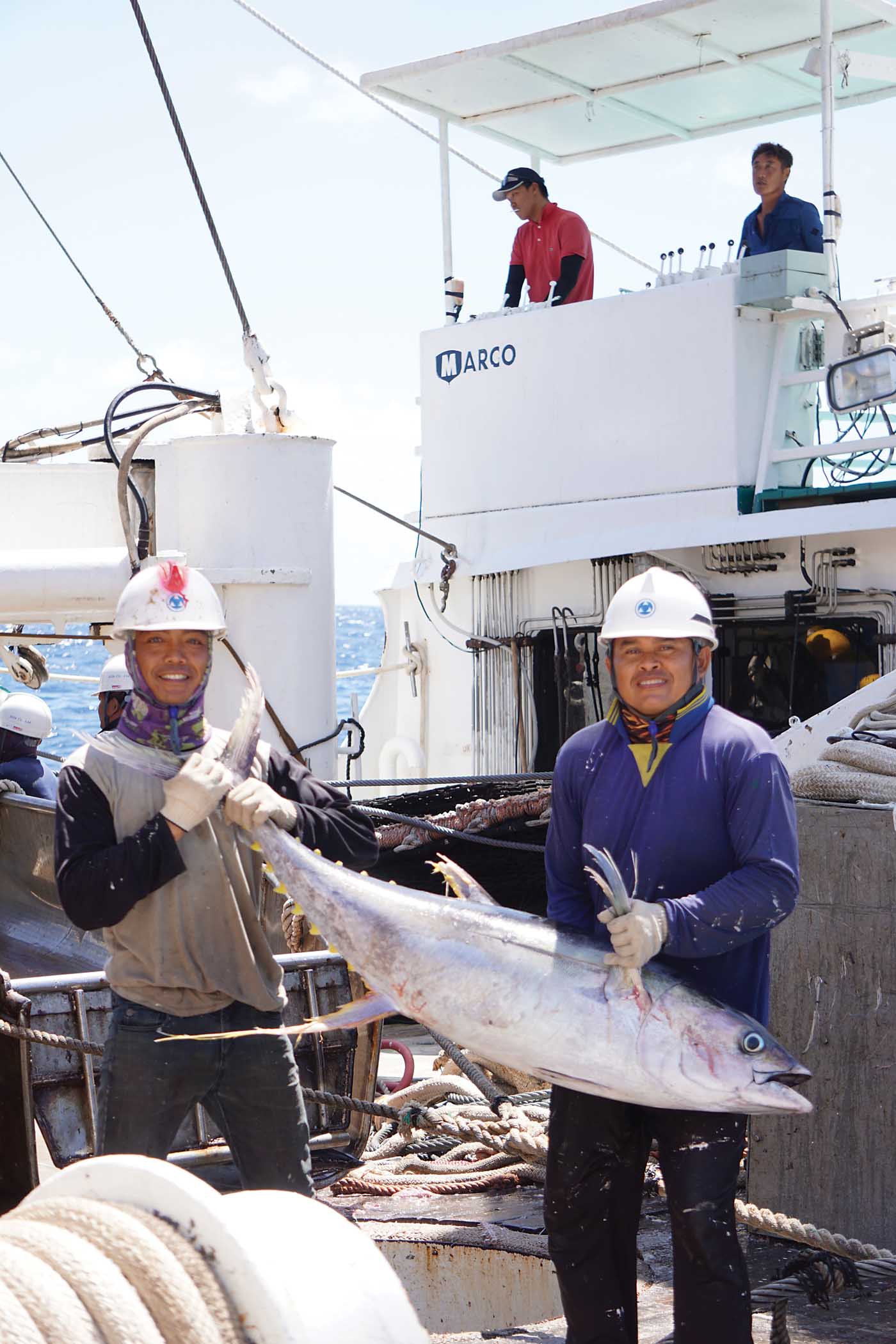 Two crewmembers pose with an average-sized yellowfin tuna. Matthew Hayes Photo