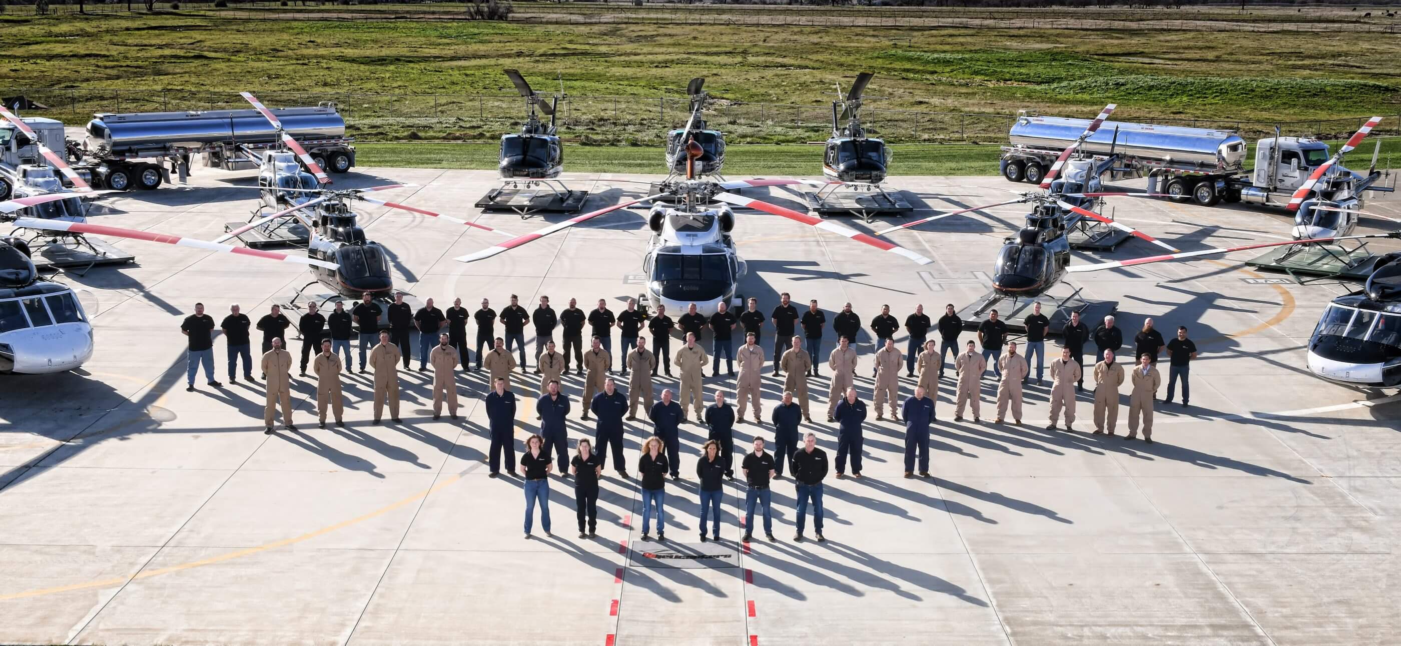PJ Helicopters' staff stand in front of some of the company's fleet outside of its headquarters in Red Bluff, California. Seth Gunsauls Photo