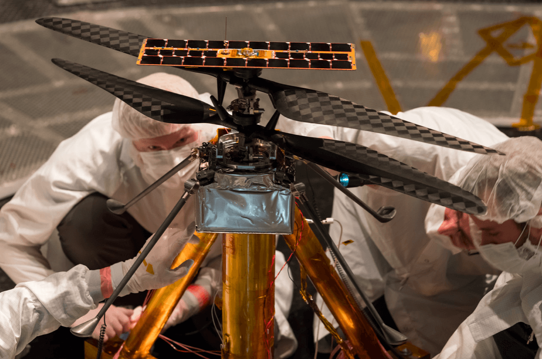 Members of the NASA Mars Helicopter team inspect the flight model (the actual vehicle going to the Red Planet), inside the space simulator at NASA's Jet Propulsion Laboratory in Pasadena, California. NASA/JPL-Caltech Photo